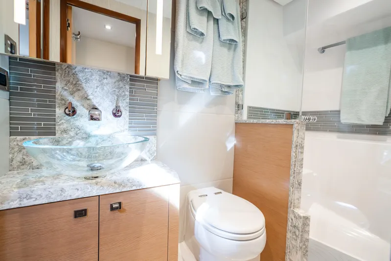 Mocean Yacht Photos Pics Luxurious bathroom in 2021 Ocean Alexander 70E Motoryacht with glass sink and modern fixtures.