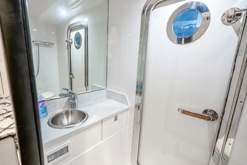 Mocean Yacht Photos Pics Luxurious bathroom in 2021 Ocean Alexander 70E Motoryacht with modern fixtures and porthole.