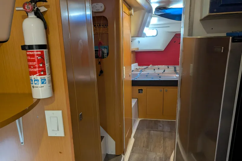 Grasshopper Yacht Photos Pics Interior of 2011 Fountaine Pajot Orana 44 Grand Large catamaran with fire extinguisher and cabin view.