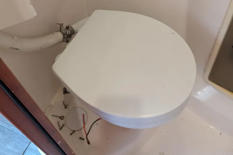 Grasshopper Yacht Photos Pics Boat bathroom with a closed toilet seat on a 2011 Fountaine Pajot Orana 44 Grand Large.