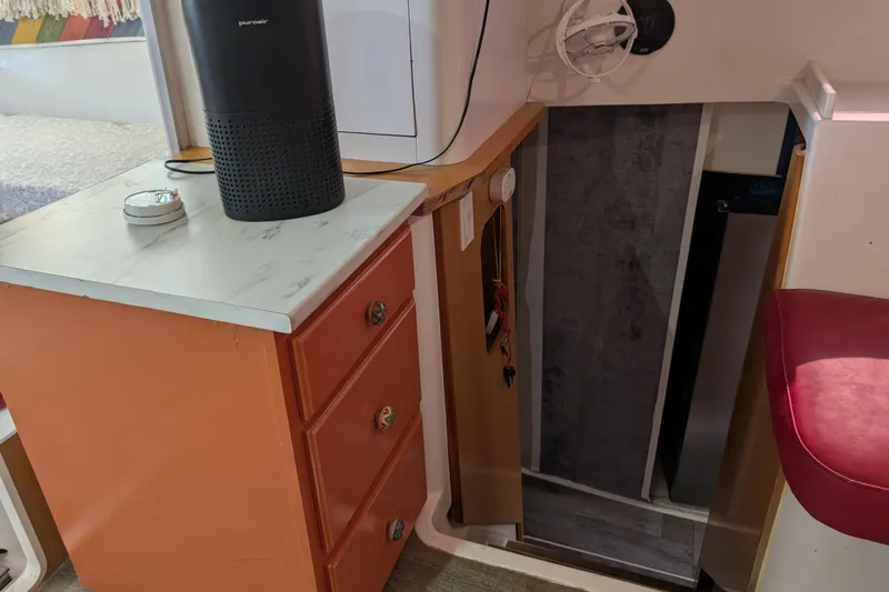 Grasshopper Yacht Photos Pics Interior of 2011 Fountaine Pajot Orana 44 Grand Large with orange drawers and stairway.