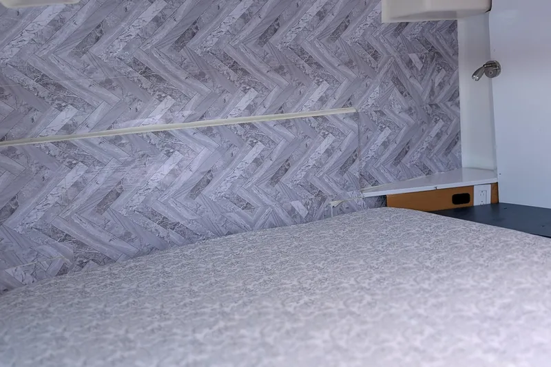 Grasshopper Yacht Photos Pics Interior of 2011 Fountaine Pajot Orana 44 Grand Large with patterned wall and bed.