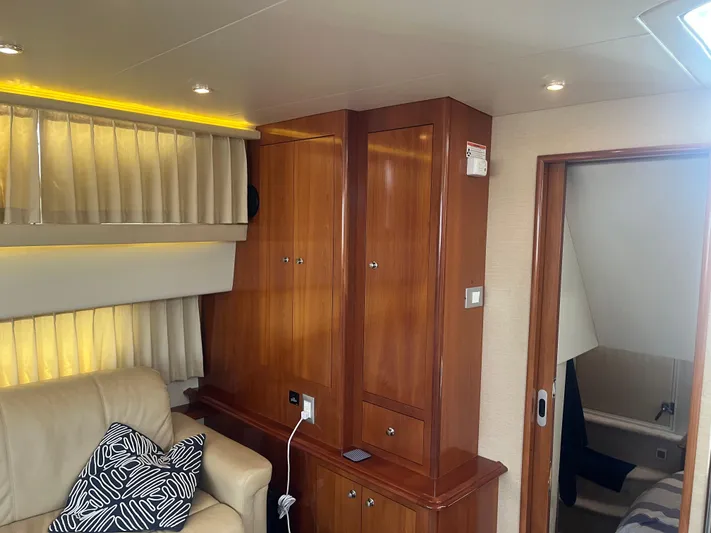  Yacht Photos Pics Interior of 2006 Carver 430 Cockpit Motor Yacht with wood cabinets and leather seating.