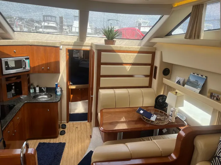  Yacht Photos Pics Interior of 2006 Carver 430 Cockpit Motor Yacht with kitchen and dining area.