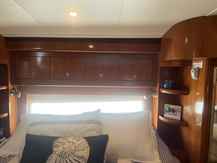  Yacht Photos Pics Interior of 2006 Carver 430 Cockpit Motor Yacht with wooden cabinets and cozy bedding.