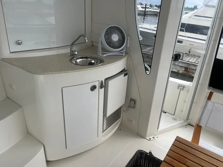  Yacht Photos Pics 2006 Carver 430 Cockpit Motor Yacht interior with sink, fan, and wooden table.