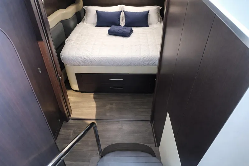  Yacht Photos Pics 2019 Regal 42 Grande Coupe cabin with bed, dark wood accents, and modern design.