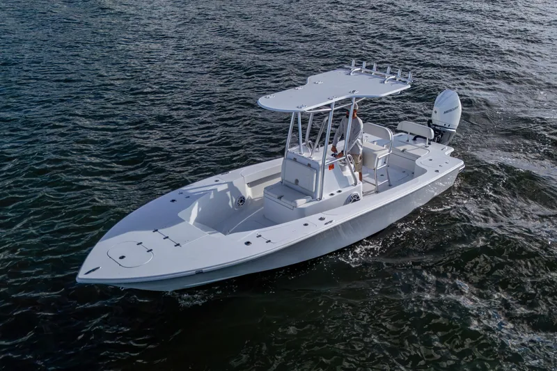  Yacht Photos Pics 2022 Conch 25 boat cruising on open water, featuring sleek design and modern outboard motor.