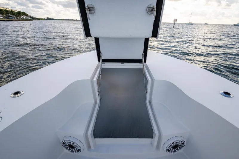  Yacht Photos Pics 2022 Conch 25 boat deck with open hatch, ocean view in background.