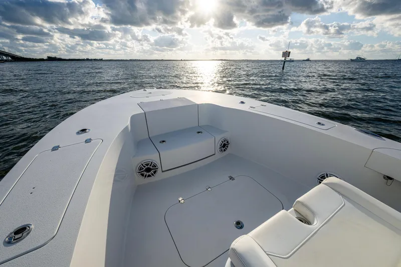  Yacht Photos Pics 2022 Conch 25 boat interior with seating, ocean view, and cloudy sky.