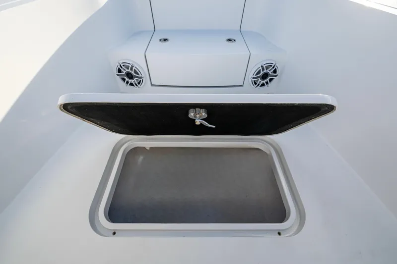  Yacht Photos Pics Open storage compartment on 2022 Conch 25 boat with speakers visible.
