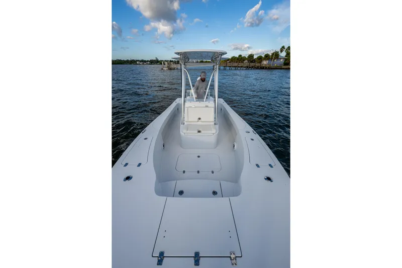  Yacht Photos Pics 2022 Conch 25 boat on water, clear sky, person at helm.