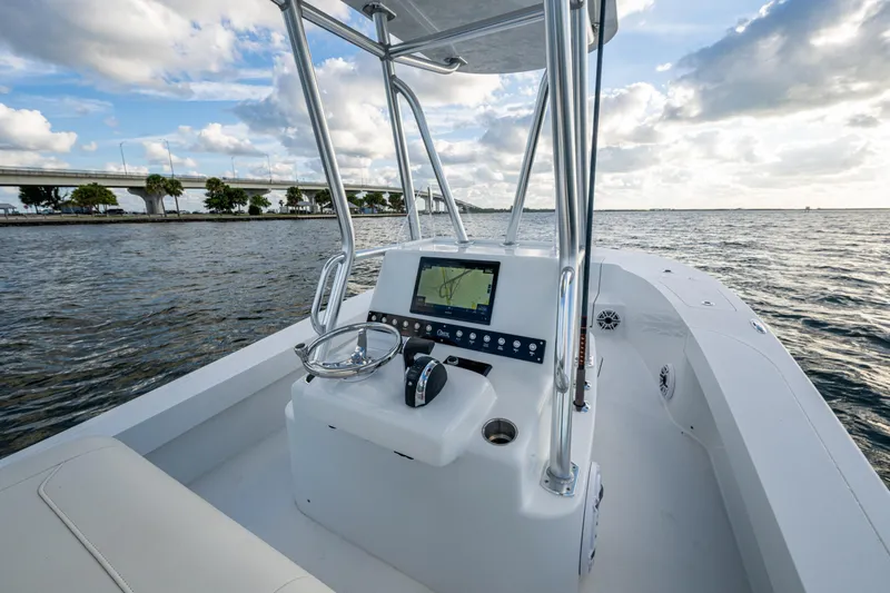  Yacht Photos Pics 2022 Conch 25 boat with modern console on open water, bridge in background.