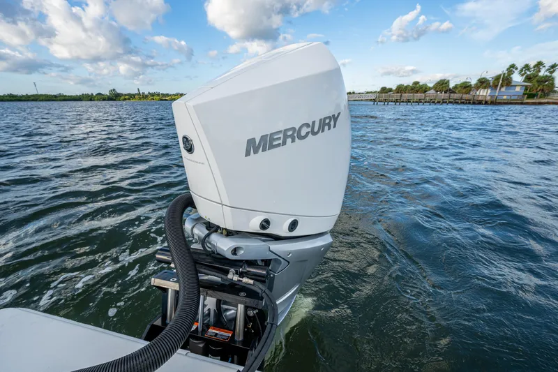  Yacht Photos Pics 2022 Conch 25 boat with Mercury outboard motor on a scenic waterway.