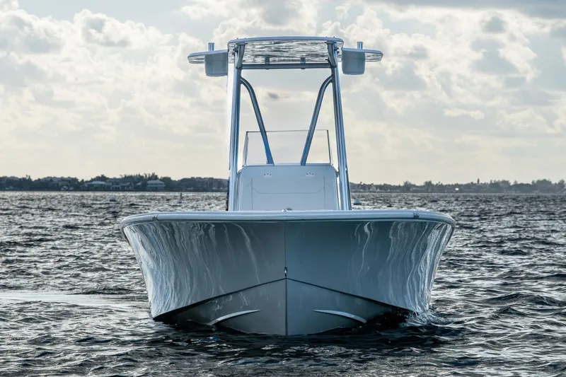  Yacht Photos Pics 2022 Conch 25 boat on water, front view under cloudy sky.