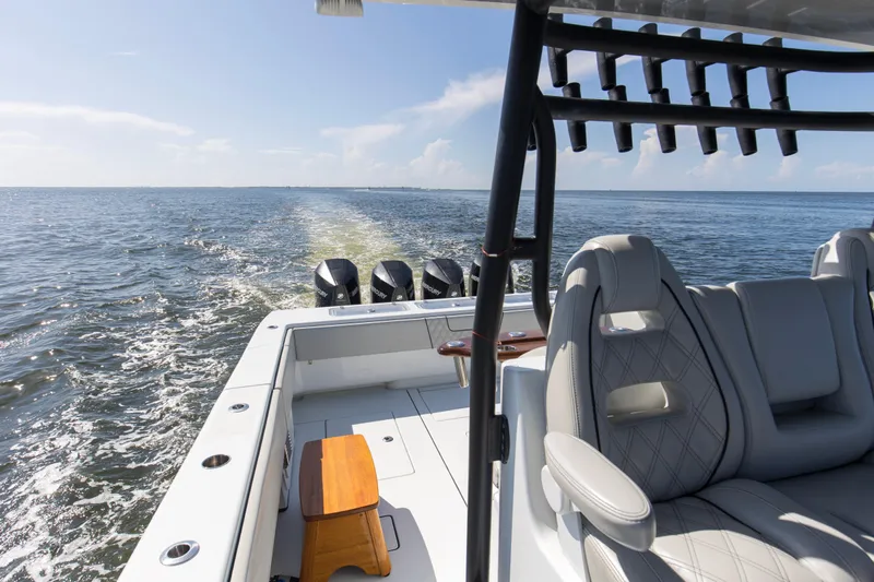 One More Yacht Photos Pics 2022 Contender 44 ST boat cruising on open water, featuring luxurious seating and multiple engines.