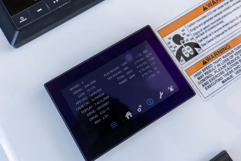 One More Yacht Photos Pics Control panel display on 2022 Contender 44 ST boat with warning labels.