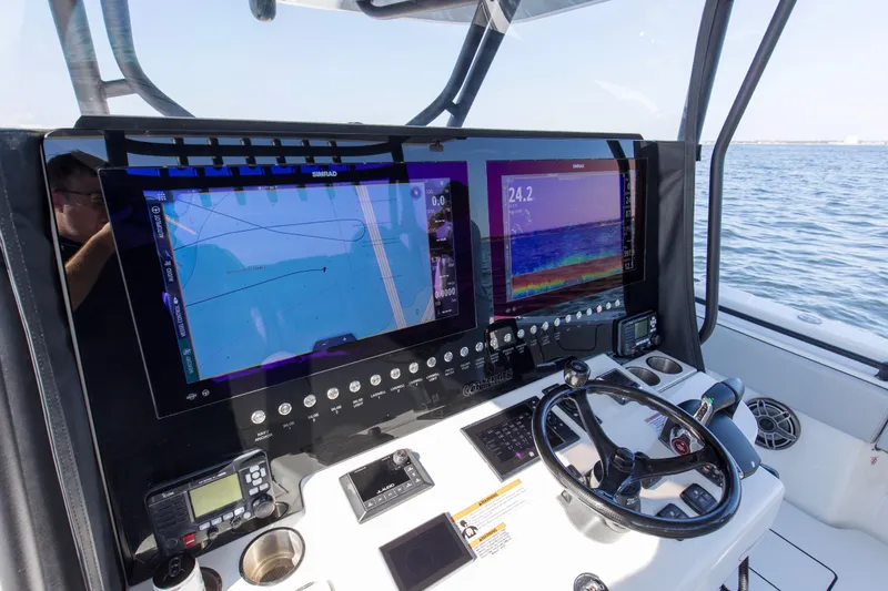 One More Yacht Photos Pics 2022 Contender 44 ST boat dashboard with navigation screens and controls.