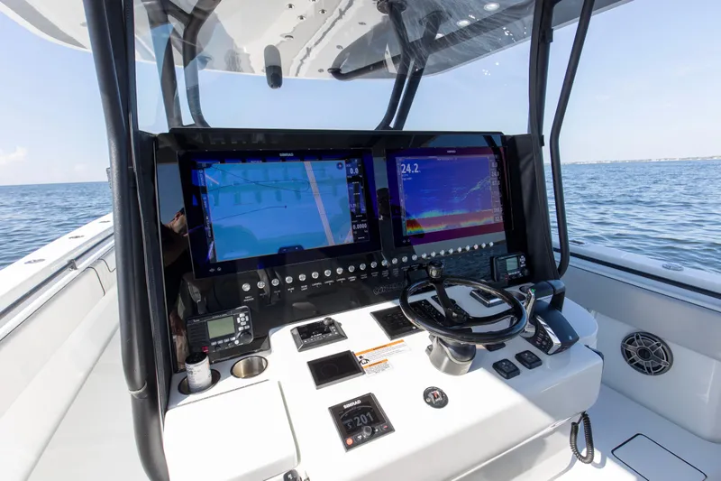 One More Yacht Photos Pics 2022 Contender 44 ST boat cockpit with advanced navigation displays and steering wheel.