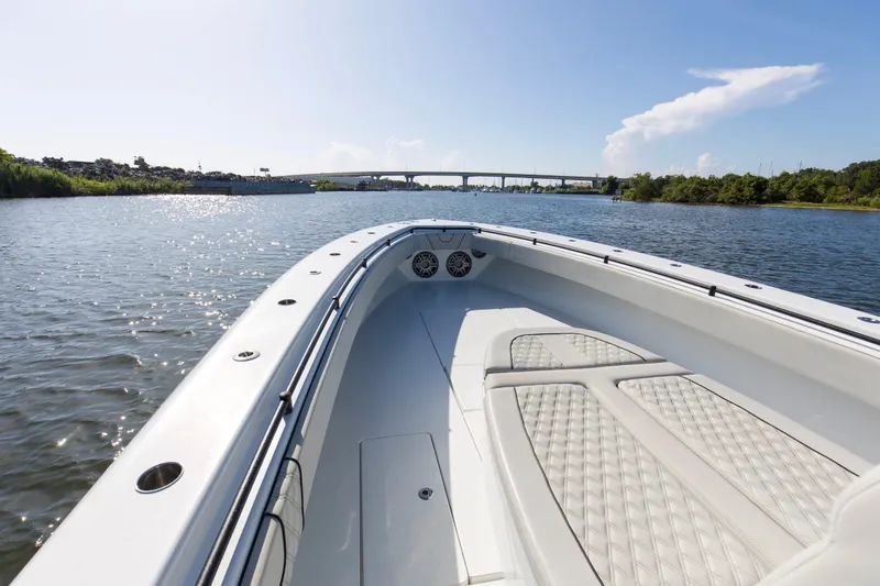 One More Yacht Photos Pics 2022 Contender 44 ST boat on calm water with bridge in background.