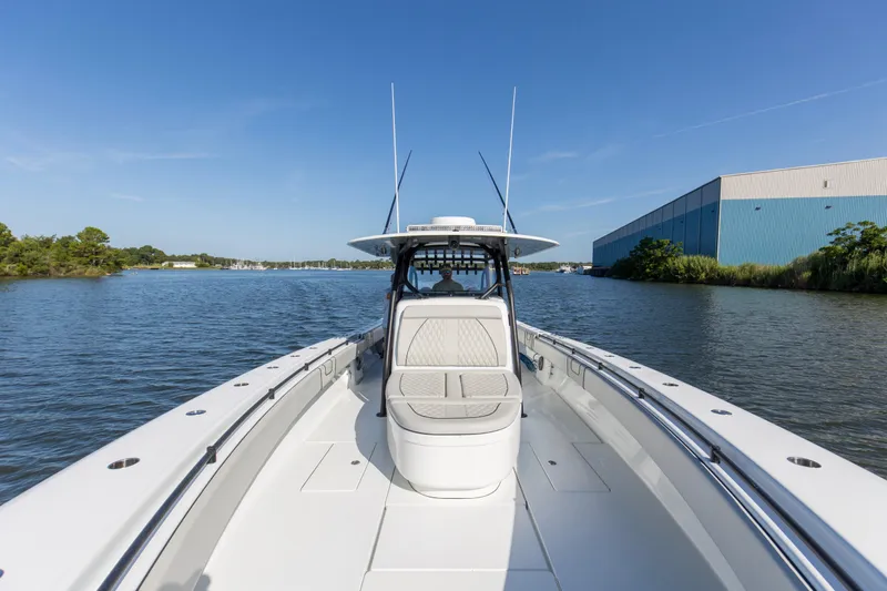 One More Yacht Photos Pics 2022 Contender 44 ST boat on calm water near industrial building.