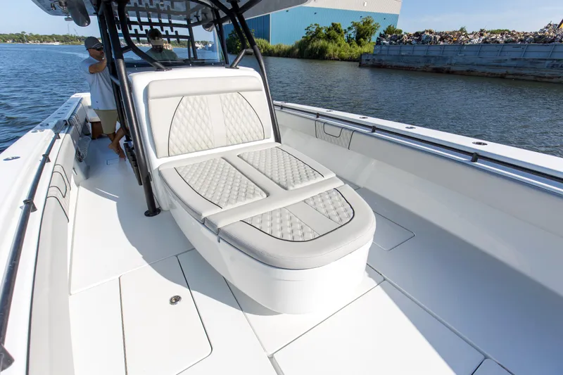 One More Yacht Photos Pics 2022 Contender 44 ST boat with luxurious seating on a calm waterway.