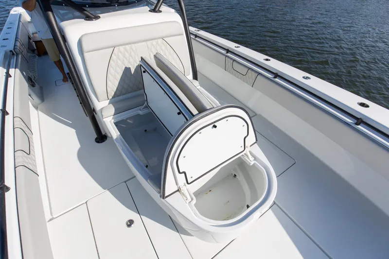 One More Yacht Photos Pics 2022 Contender 44 ST boat with open storage compartment on deck, near water.