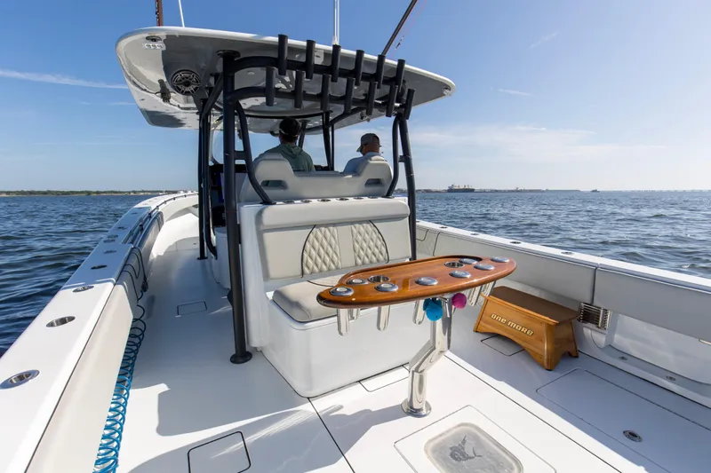 One More Yacht Photos Pics 2022 Contender 44 ST boat on open water, featuring a spacious deck and seating area.