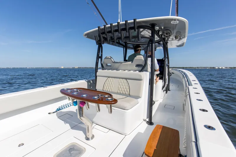 One More Yacht Photos Pics 2022 Contender 44 ST boat on open water, featuring spacious deck and seating.