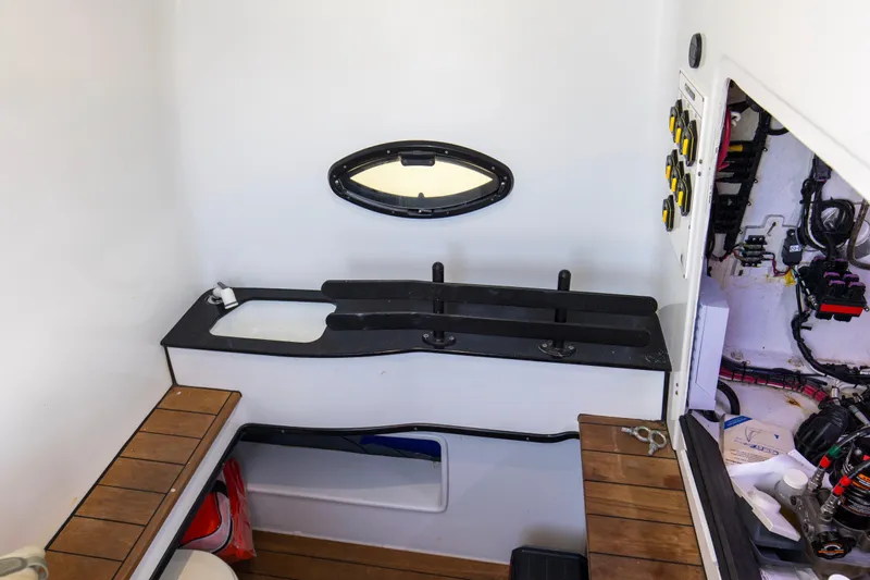 One More Yacht Photos Pics 2022 Contender 44 ST boat interior with sink, storage, and control panel.