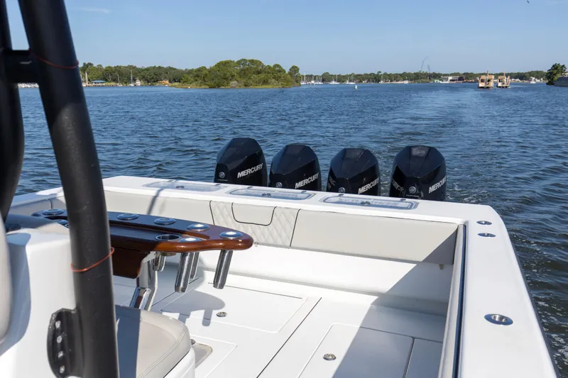 One More Yacht Photos Pics 2022 Contender 44 ST boat with four Mercury engines on a calm waterway.