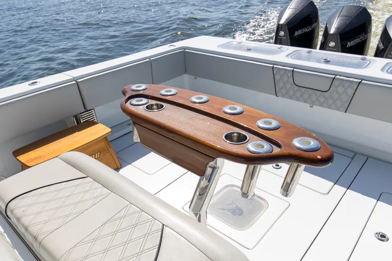 One More Yacht Photos Pics 2022 Contender 44 ST boat interior with wooden rod holder and Mercury engines.