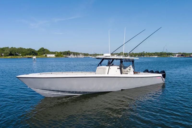 One More Yacht Photos Pics 2022 Contender 44 ST boat on calm water under clear blue sky.