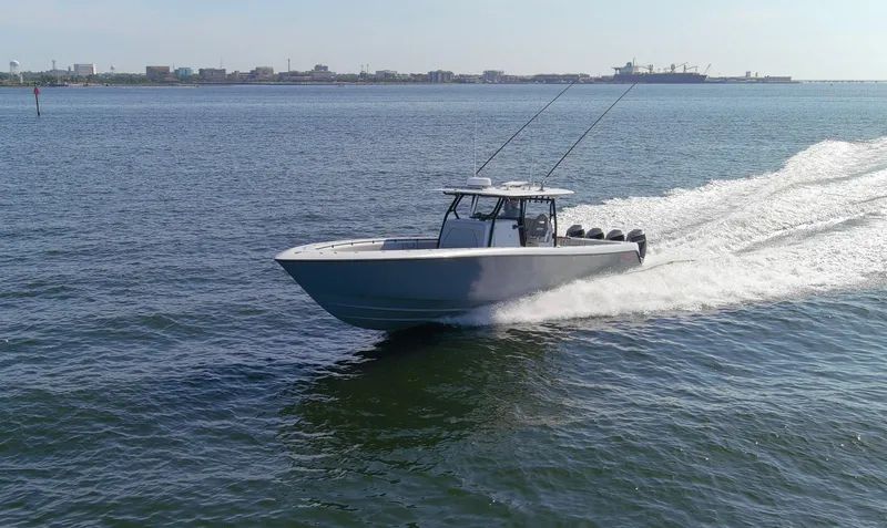 One More Yacht Photos Pics 2022 Contender 44 ST boat cruising on open water, cityscape in background.