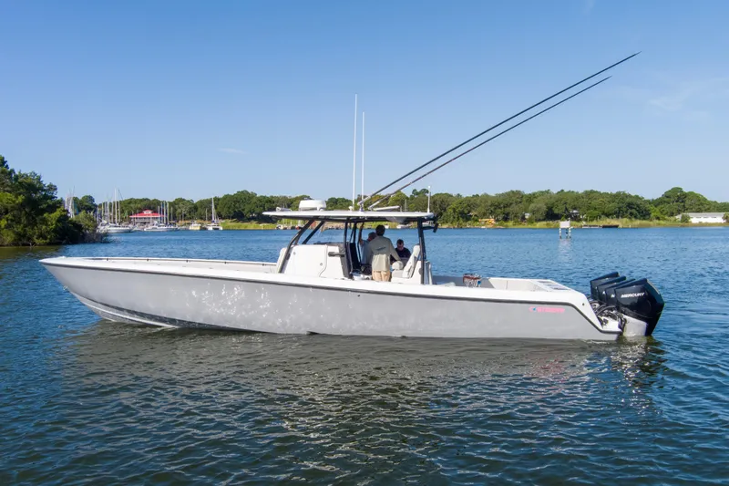 One More Yacht Photos Pics 2022 Contender 44 ST boat on a calm lake with clear blue skies.