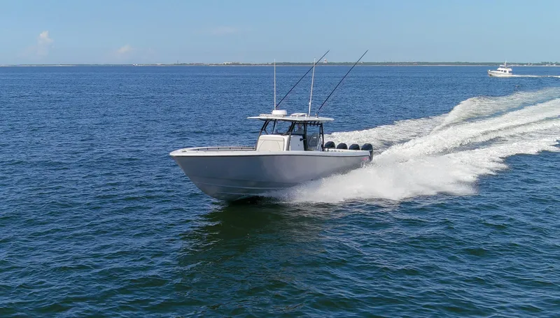 One More Yacht Photos Pics 2022 Contender 44 ST boat cruising on open water, creating a wake.