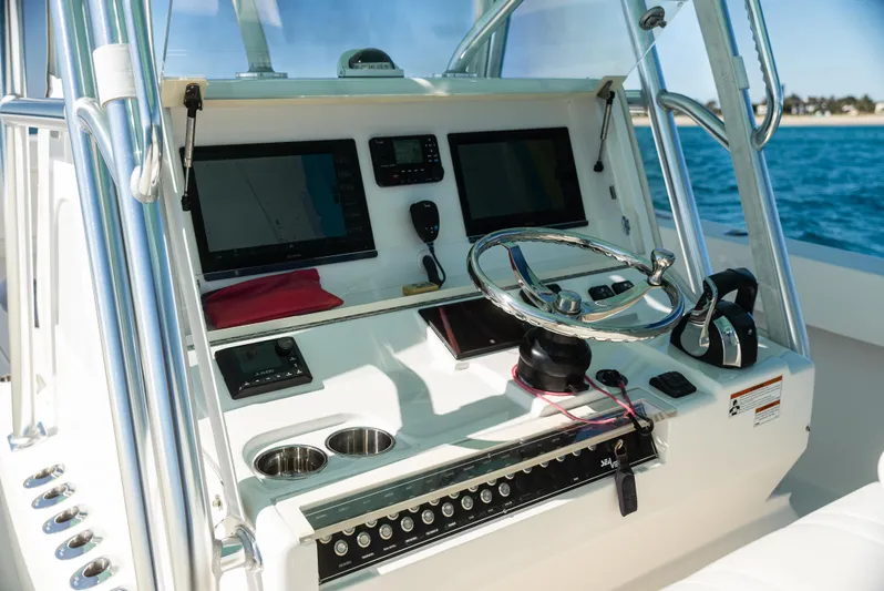  Yacht Photos Pics 2022 SeaVee 390Z boat dashboard with steering wheel and navigation screens.