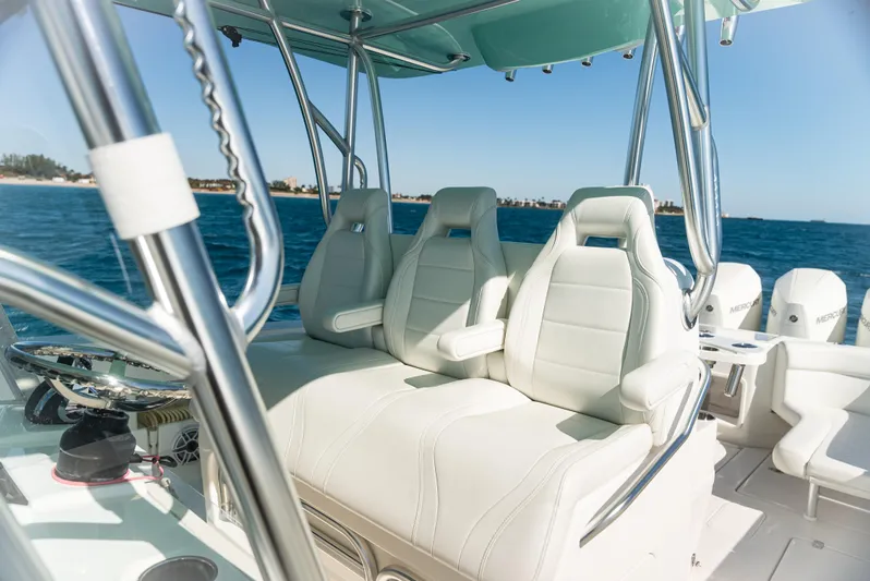  Yacht Photos Pics 2022 SeaVee 390Z boat interior with white seating, ocean backdrop.