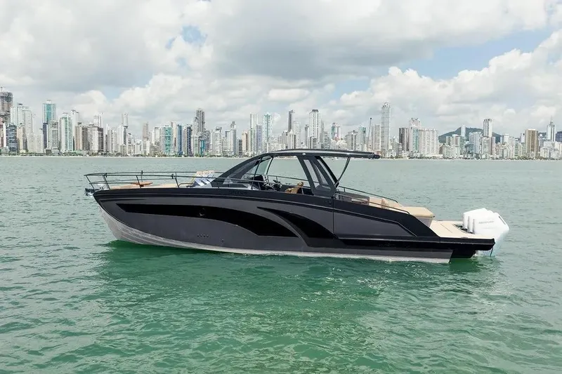  Yacht Photos Pics 2025 Hanover 447 Ultimate Luxury Edition yacht on water with city skyline backdrop.