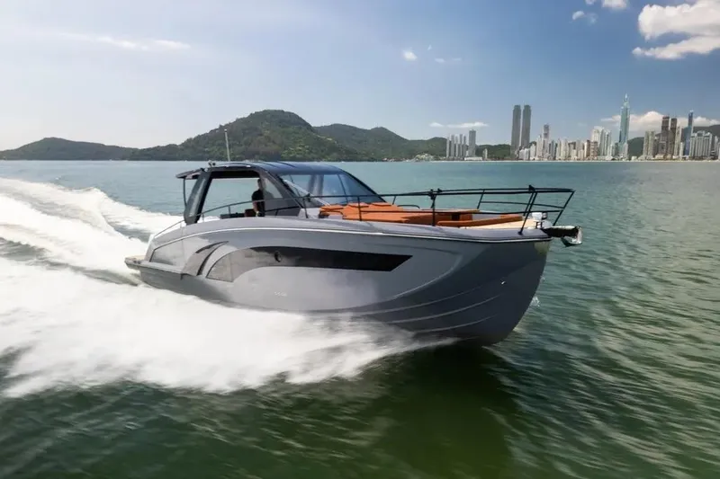  Yacht Photos Pics 2025 Hanover 447 Ultimate Luxury Edition yacht cruising near city skyline.