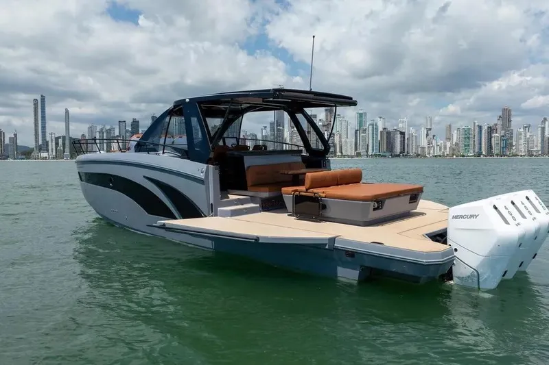  Yacht Photos Pics Luxury Hanover 447 yacht cruising near city skyline, 2025 model, featuring sleek design and powerful engines.