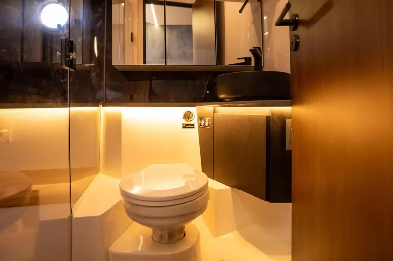  Yacht Photos Pics Luxurious bathroom in 2025 Hanover 447 Ultimate Luxury Edition yacht, featuring modern fixtures and ambient lighting.