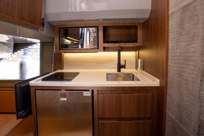  Yacht Photos Pics Luxurious kitchenette in 2025 Hanover 447 Ultimate Luxury Edition RV, featuring modern appliances.