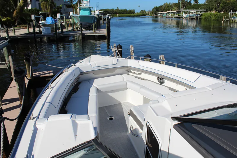  Yacht Photos Pics 2023 Formula 330 Crossover Bowrider docked by a serene waterfront.