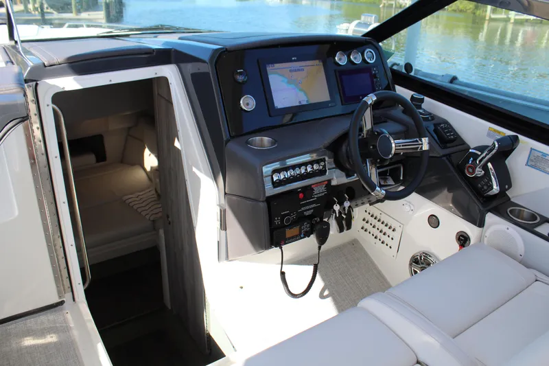  Yacht Photos Pics 2023 Formula 330 Crossover Bowrider cockpit with modern controls and cabin view.