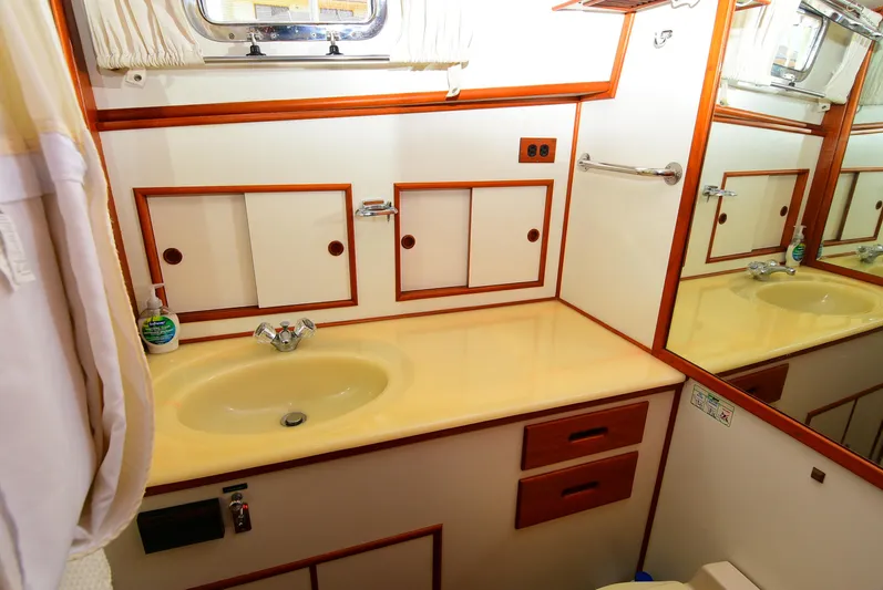  Yacht Photos Pics Bathroom interior of 1994 Grand Banks 38 Eastbay yacht with sink and storage cabinets.