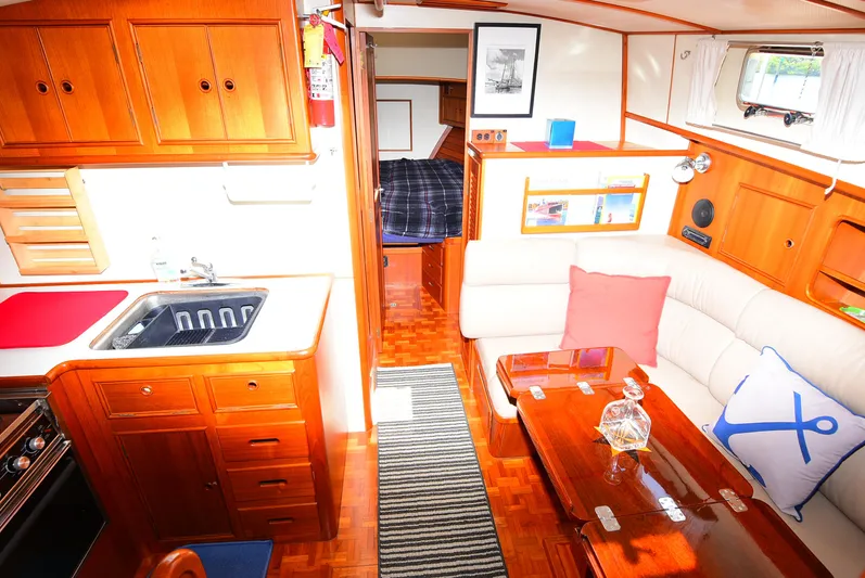  Yacht Photos Pics Interior of 1994 Grand Banks 38 Eastbay yacht with cozy seating and wooden cabinetry.