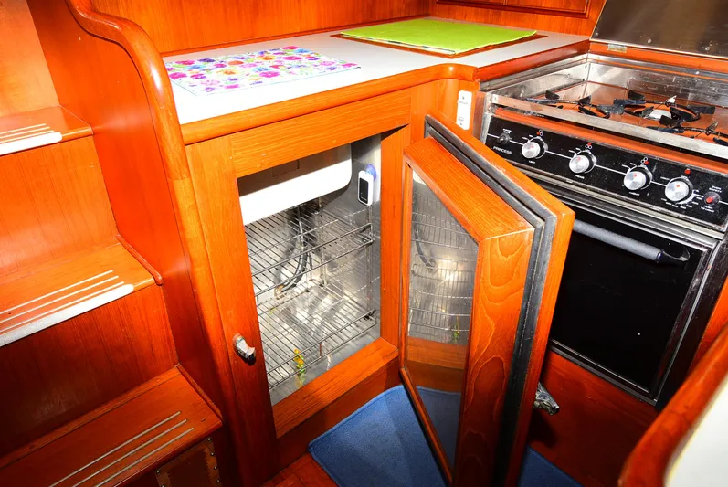  Yacht Photos Pics 1994 Grand Banks 38 Eastbay yacht kitchen with wooden cabinetry and stove.