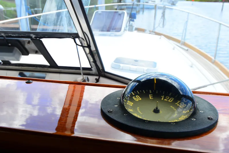  Yacht Photos Pics Compass on 1994 Grand Banks 38 Eastbay yacht, reflecting sky and water.
