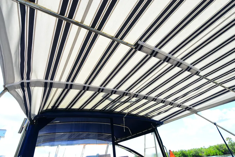  Yacht Photos Pics Striped canopy on 1994 Grand Banks 38 Eastbay boat, providing shade and style.